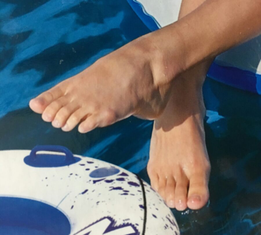 Girl with sexy feet on an inflatable raft box.