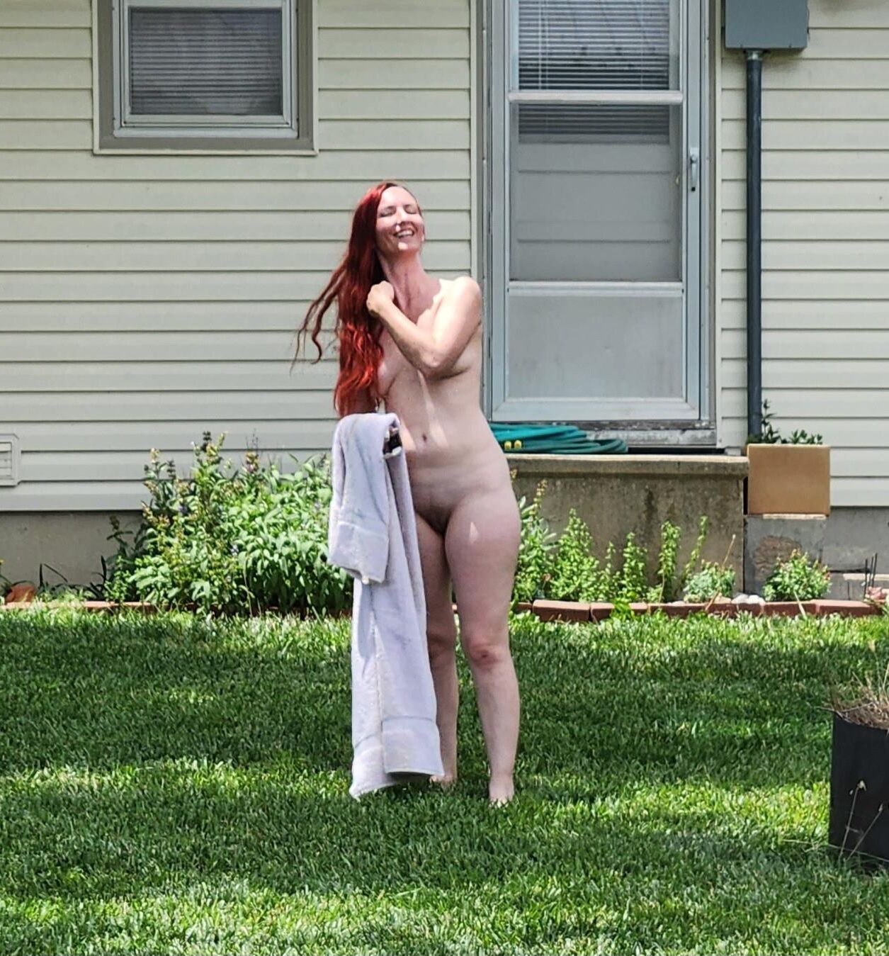 Redhead me sun tanning in back yard.