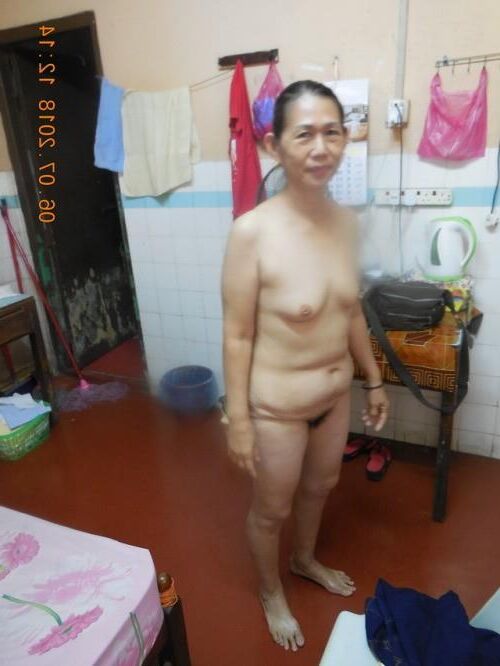 Plain looking mature Asians standing topless