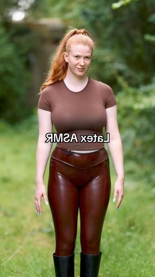 Hot red hair girl in latex leggings