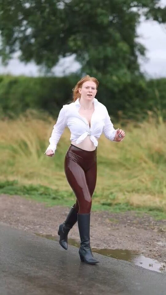 Hot red hair girl in latex leggings