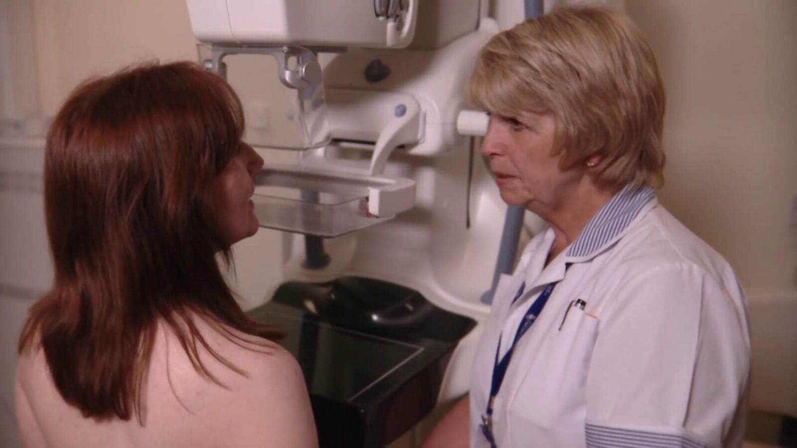 Mature redhead woman having a mammogram