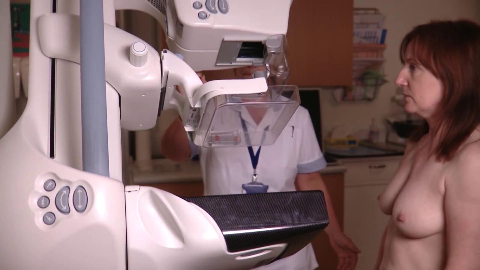 Mature redhead woman having a mammogram