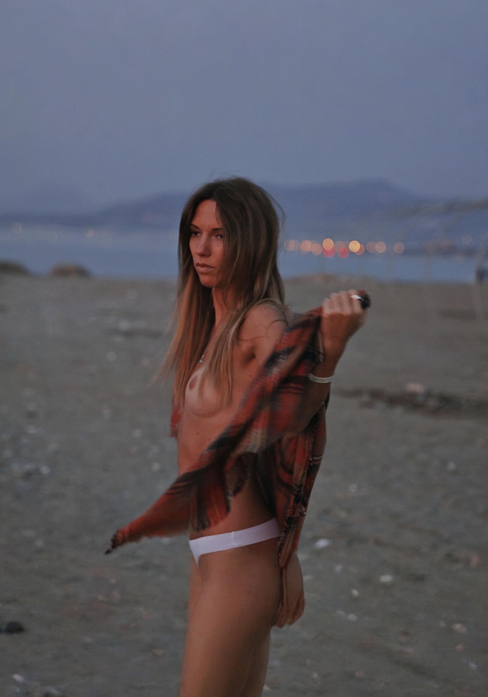 Pretty young Russian wife is posing on public beach 