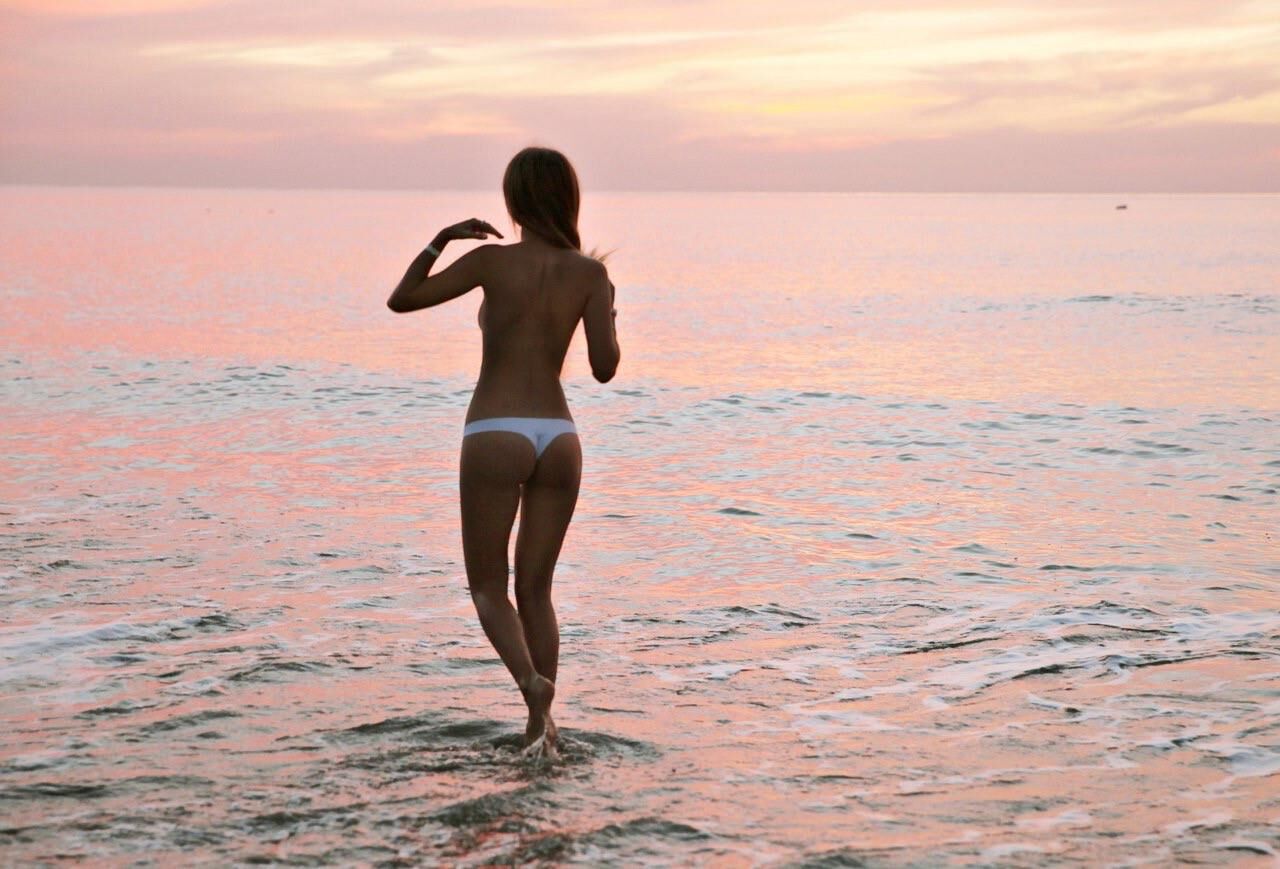 Pretty young Russian wife is posing on public beach 