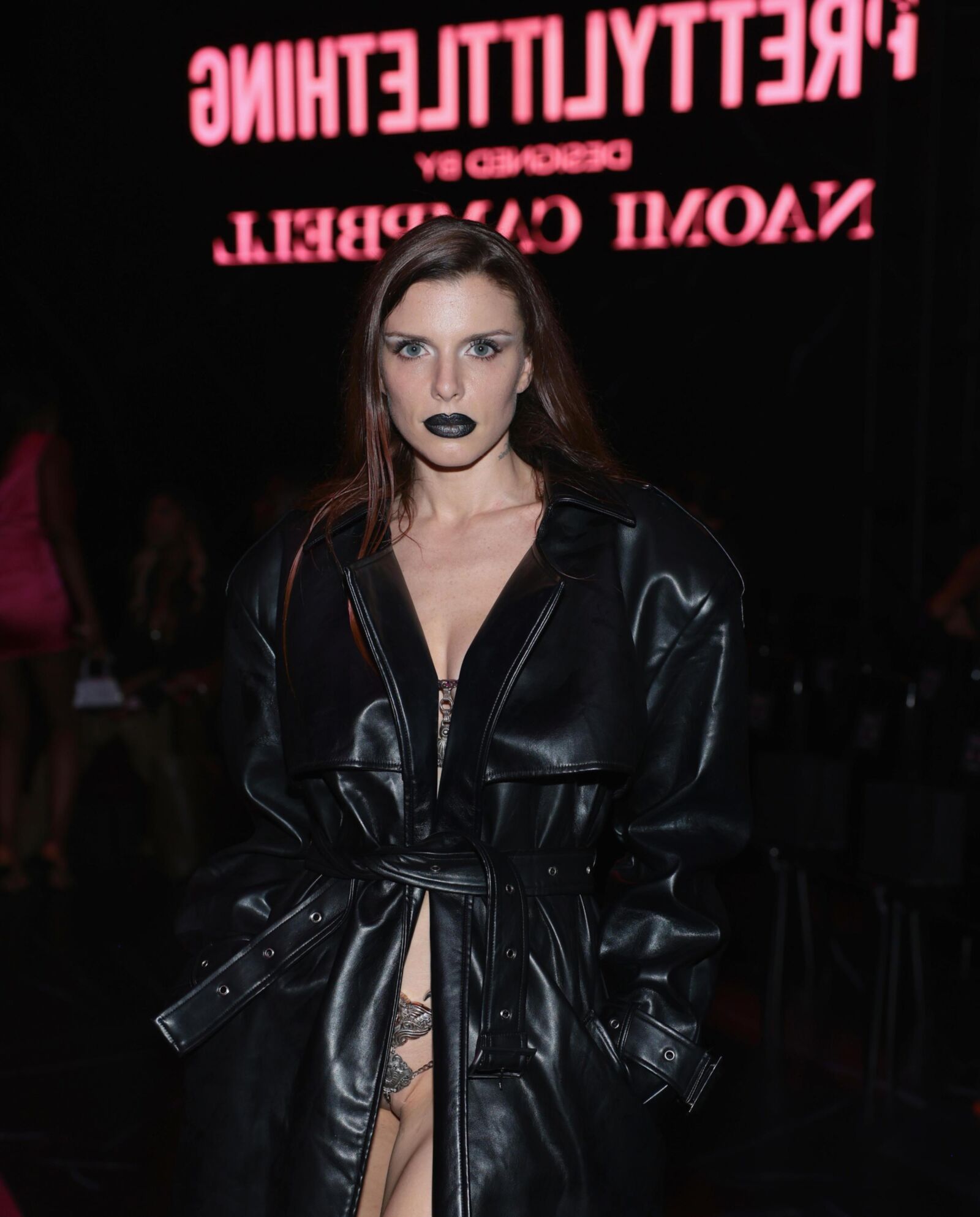 Julia fox wearing a sexy chain outfit under a black trench coat 