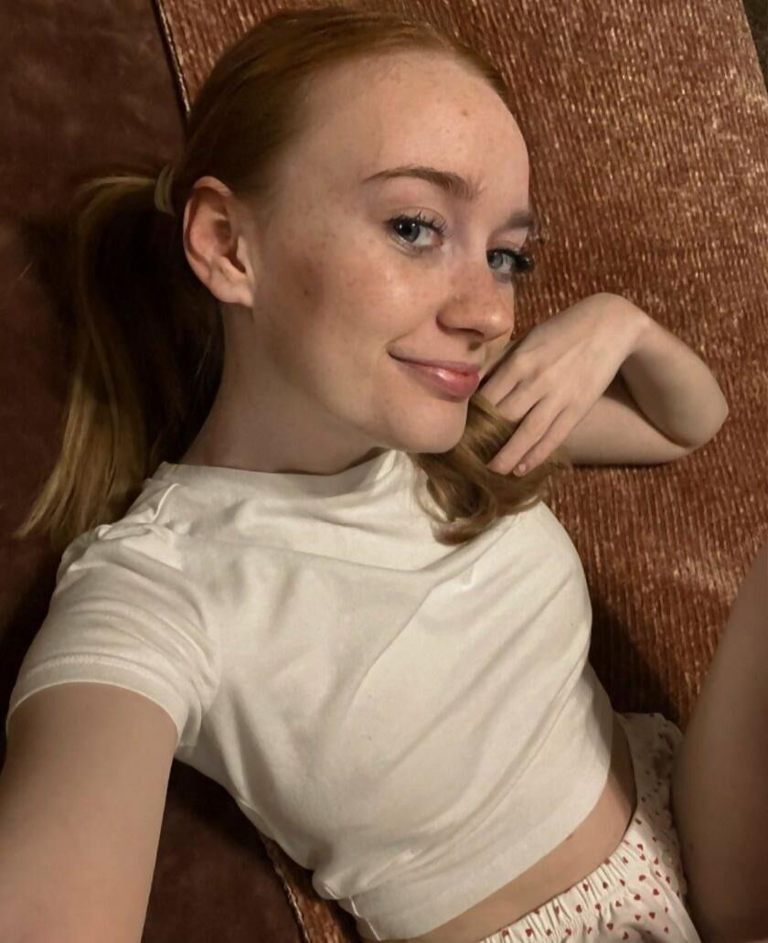 Redhead with a pretty smile and a nice body