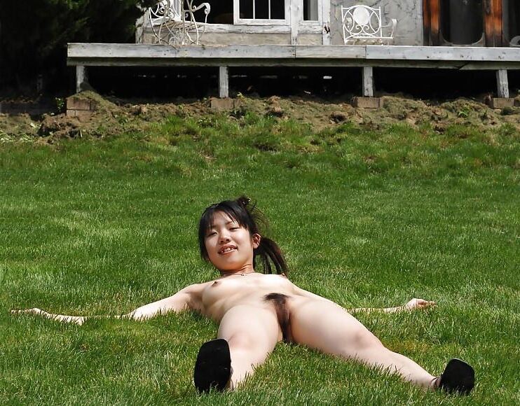 Japanese girl frolicks naked in a garden